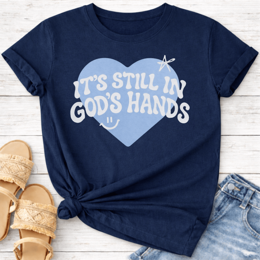 IT'S STILL IN GOD'S HANDS T-SHIRT
