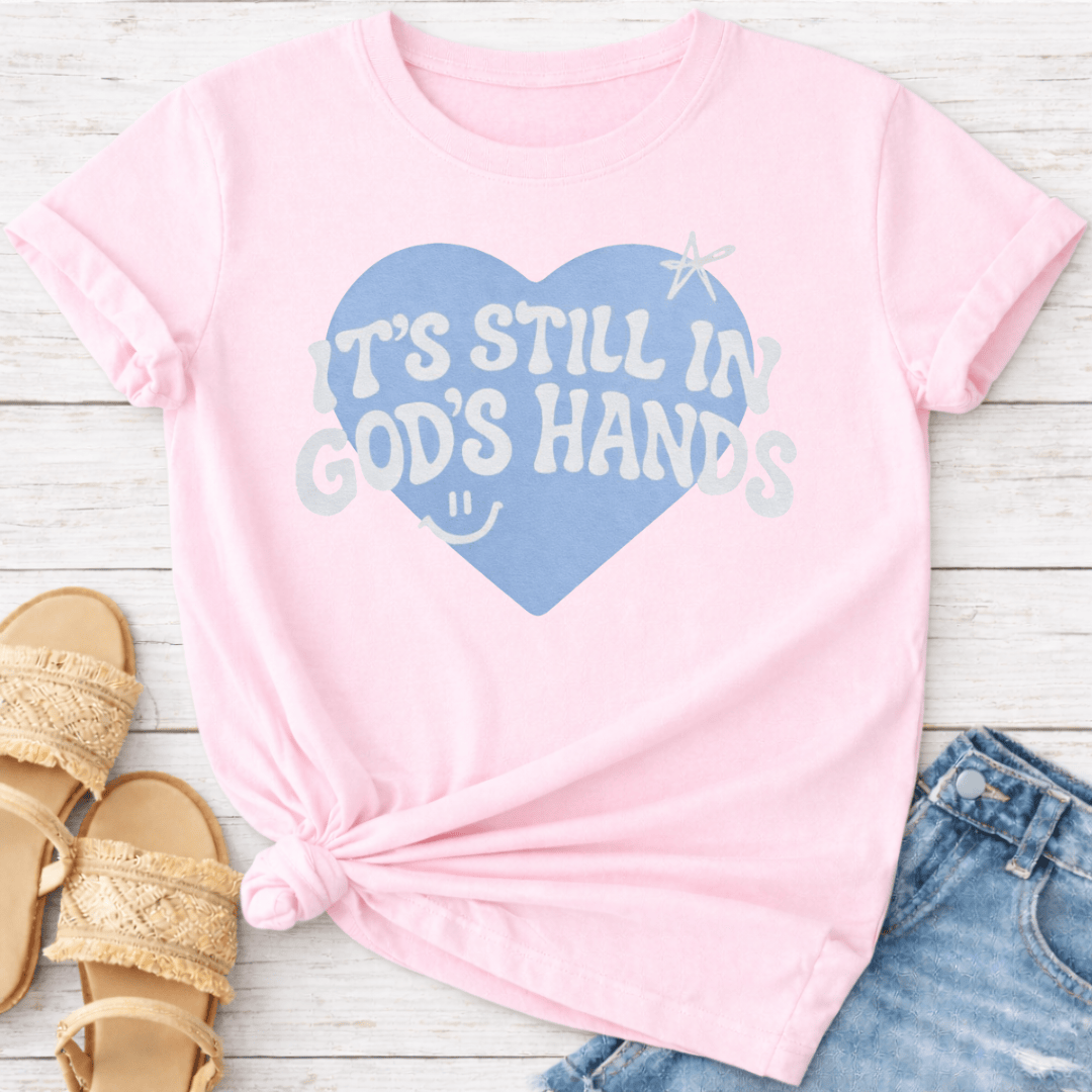 IT'S STILL IN GOD'S HANDS T-SHIRT