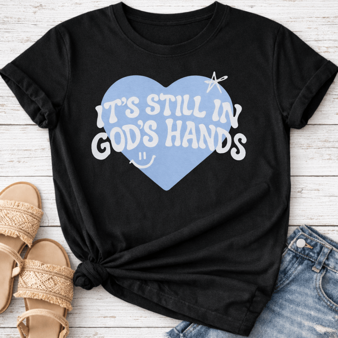 IT'S STILL IN GOD'S HANDS T-SHIRT