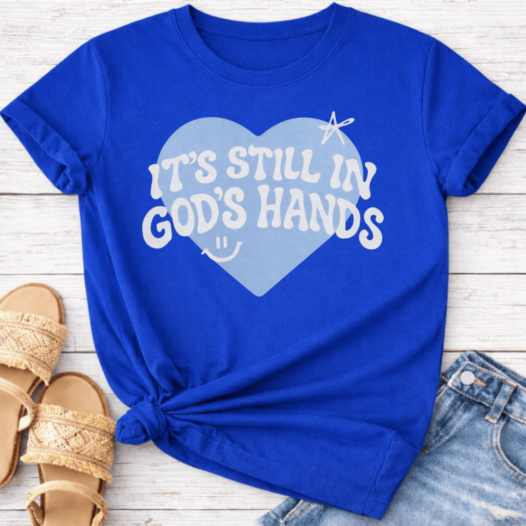 IT'S STILL IN GOD'S HANDS T-SHIRT