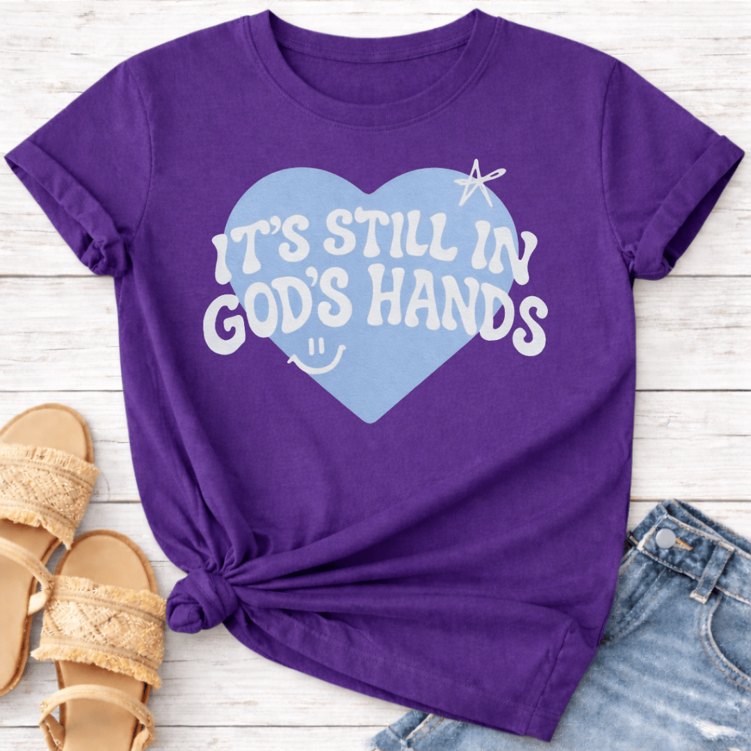 IT'S STILL IN GOD'S HANDS T-SHIRT
