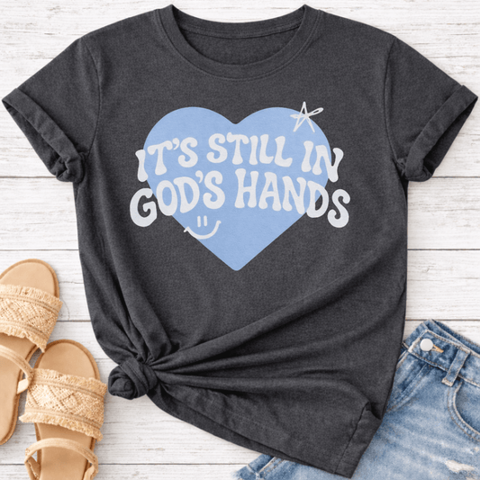 IT'S STILL IN GOD'S HANDS T-SHIRT